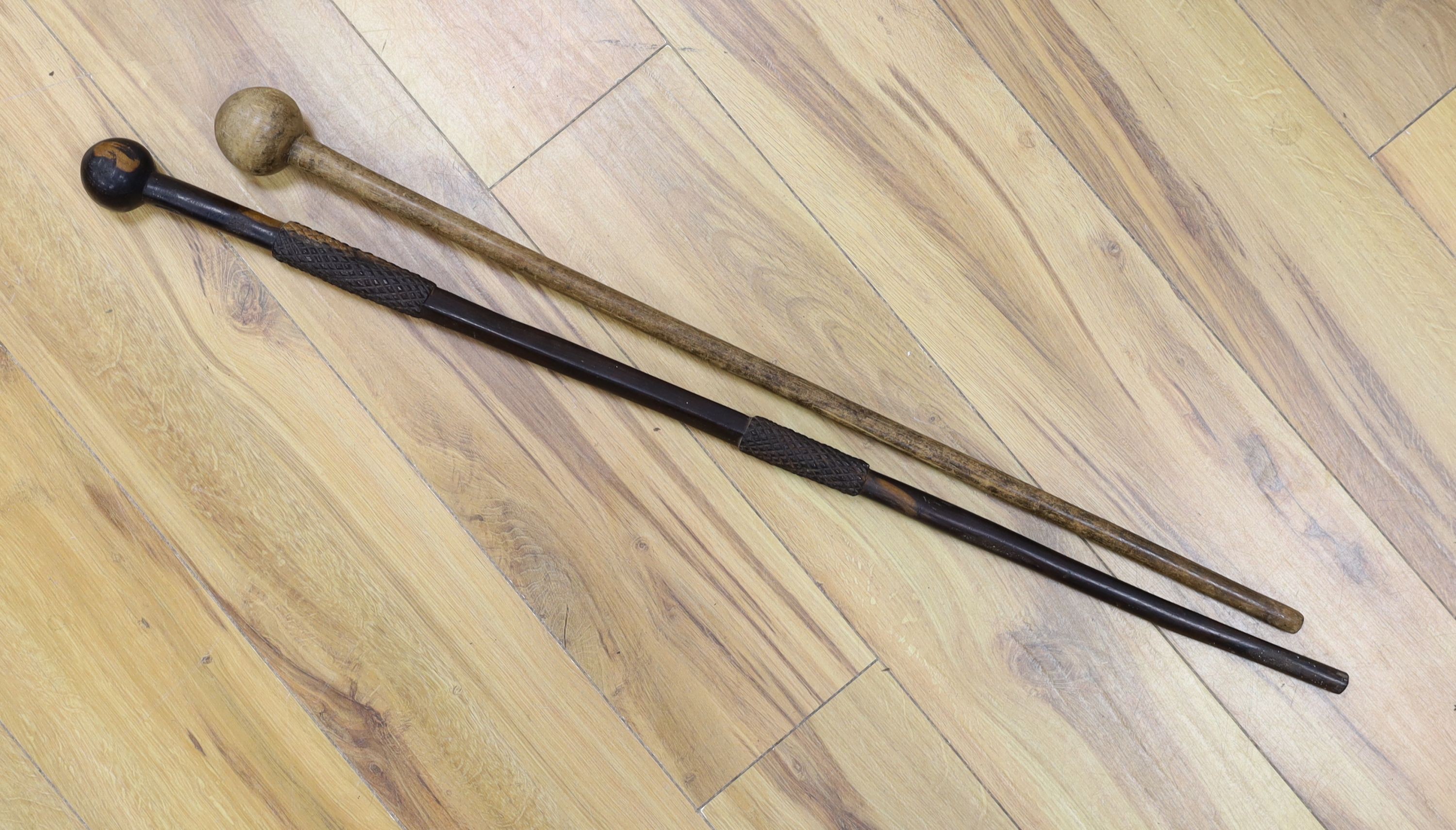 An ebony knobkerrie, 91 cms long, and another.